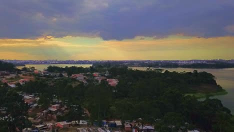 Aerial-view-flying-over-the-favelas-in-Sao-Paulo,-Brazil-at-sunset