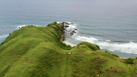 beautiful wavy green mountain hill plateau coastline at bukit merese lombok, aerial