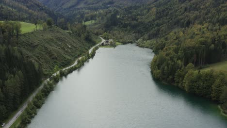 south shore of freibach reservoir in austria artificial dam, aerial dolly out reveal shot