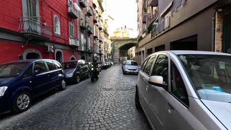 vehicles and motorbikes on a narrow street