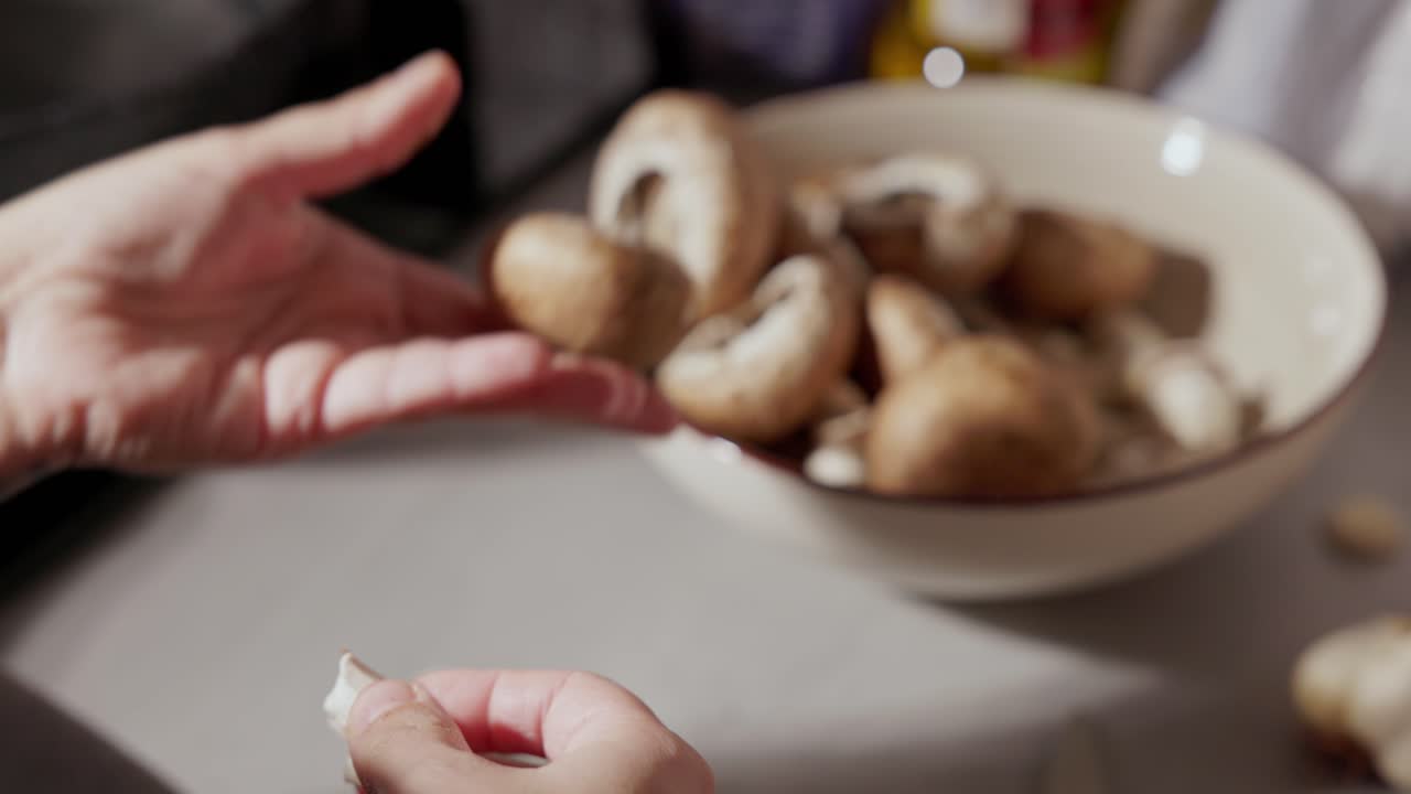 Woman's Hand Removing Stem Of Mushroom Then Placed In The Bowl