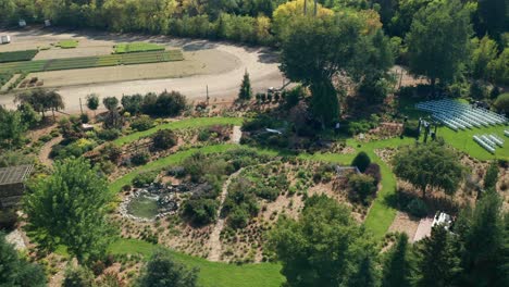 an outdoor wedding event taking place in landscaped formal parkland on a bright, sunny day