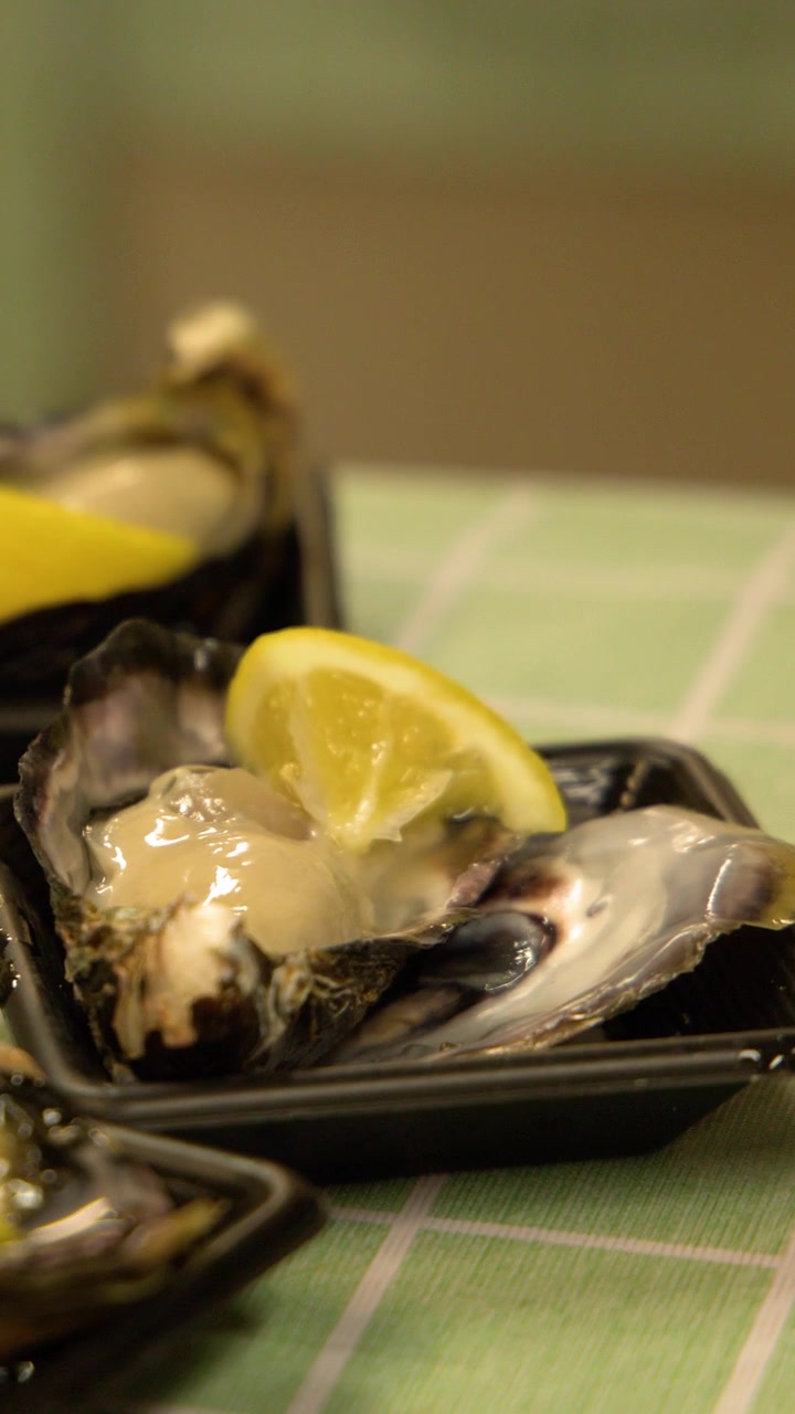 Fresh Raw Oyster Served with Lemon Slice on a Plate
