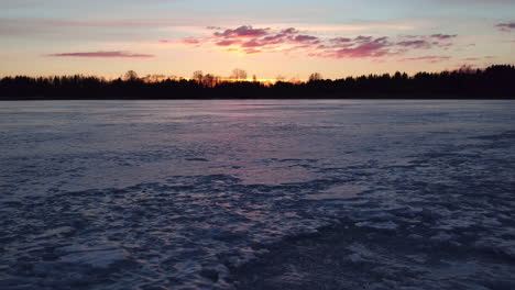 stunning cinematic shot tracking across a frozen lake in finland