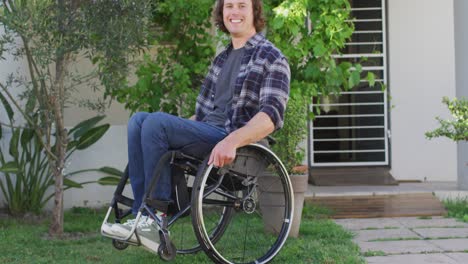 portrait of smiling caucasian disabled man in wheelchair looking at camera