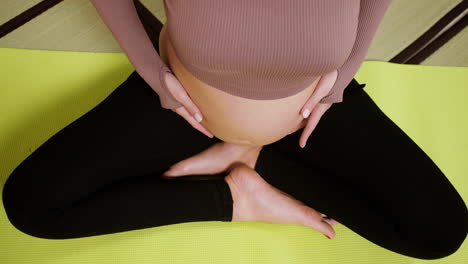 pregnant woman on yoga mat