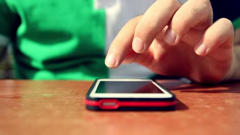 Young-Man-Using-His-Smartphone-In-A-Cafe-Close-Up-Hands-4