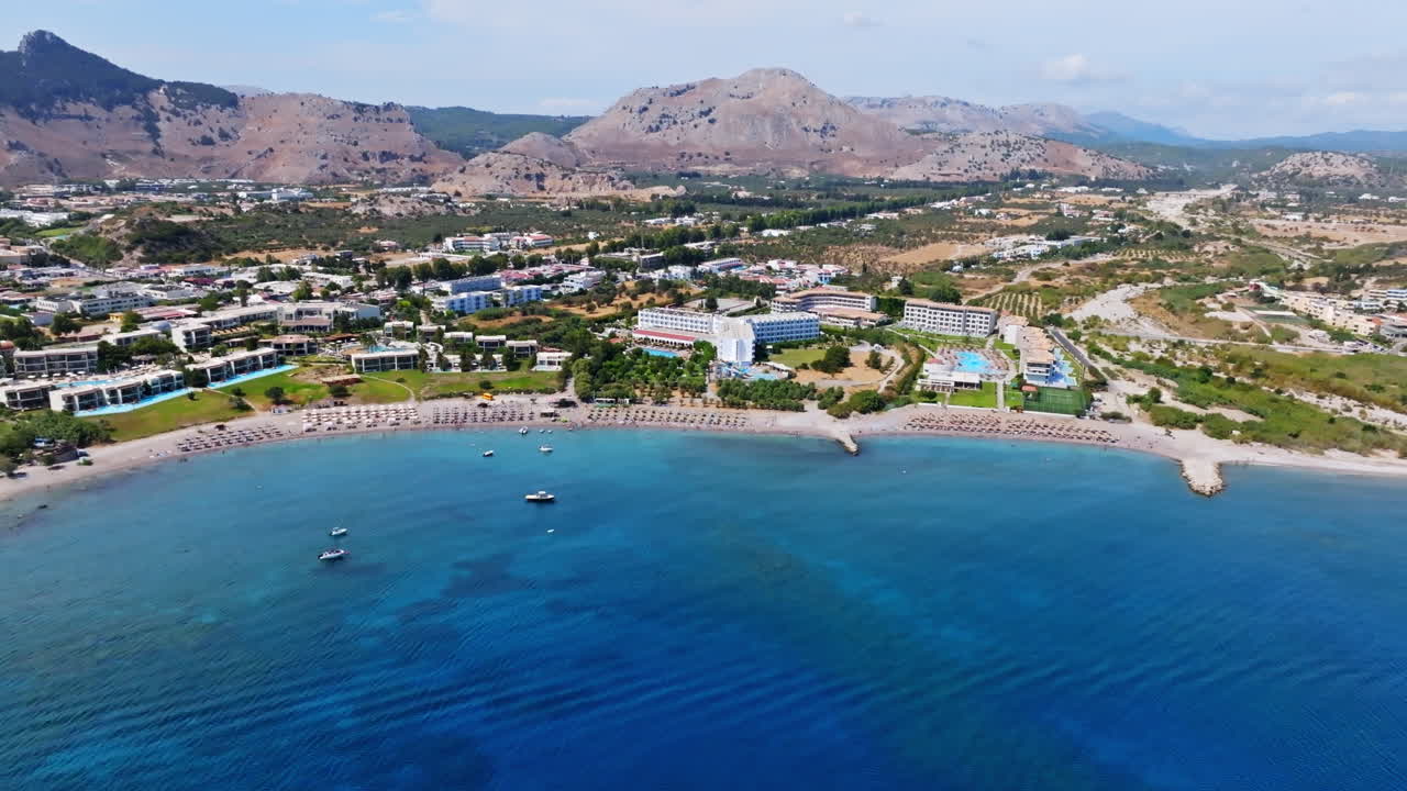 Aerial tracking shot in front of the Kolymbia town, sunny day in Rhodes, Greece