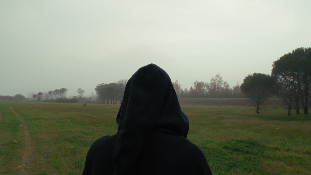 Anonymous Religious Man Raises Holy Bible To The Sky On A Dull Day