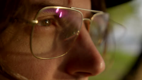 close-up profile of a person wearing glasses