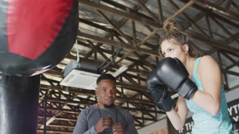 video of fit diverse woman and man boxing at gym