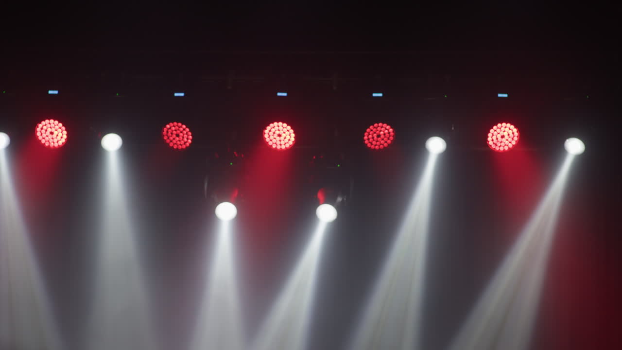 Concert Stage Lighting with Moving White and Red Beams