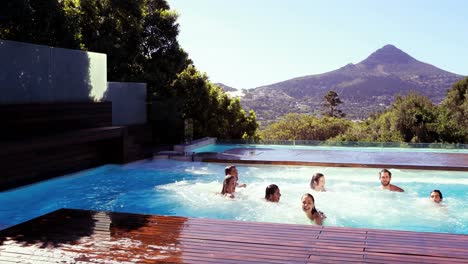 happy friends diving into the pool