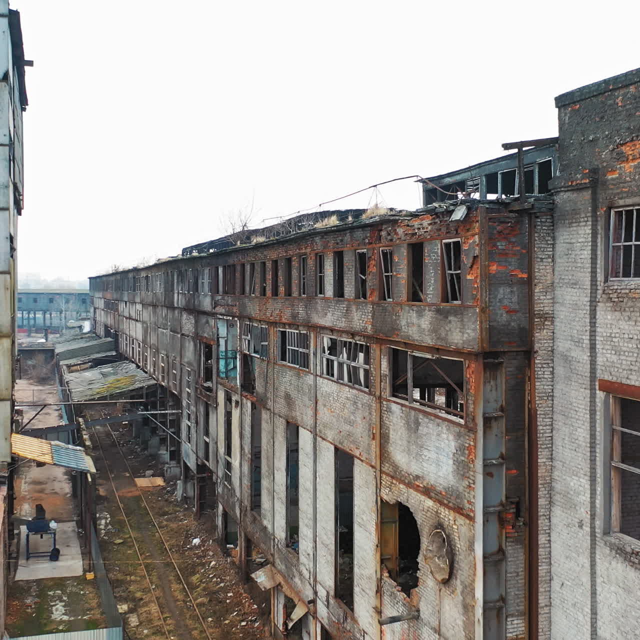 Aerial view of an old factory ruin and broken windows. Old industrial building for demolition.