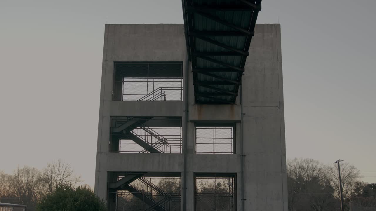 A large structure with stairs at dusk