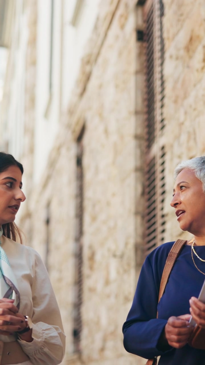 Two Professional Women Having a Conversation Outdoors
