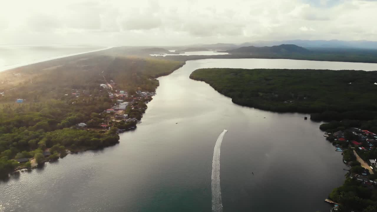 Aerial view of Chacahua's lagoon meeting the sea, a surfers' paradise