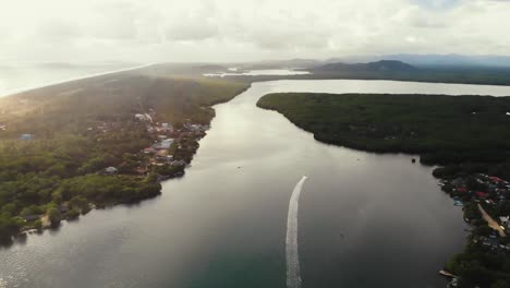 Aerial-view-of-Chacahua's-lagoon-meeting-the-sea,-a-surfers'-paradise