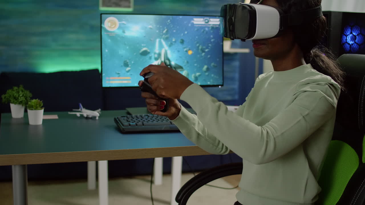 Black woman player with vr goggles raising hands holding joystick