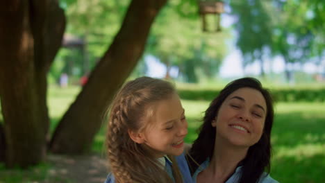 happy kids cuddling mother on summer picnic close up. joyful family rest concept