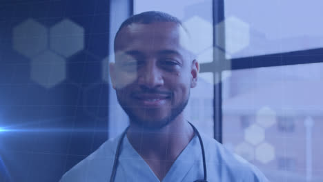 animation of light spots over smiling african american male doctor taking face mask off