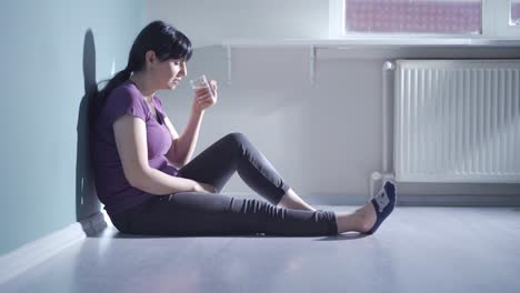 Cowardly-woman-drinks-water-with-trembling-hand.