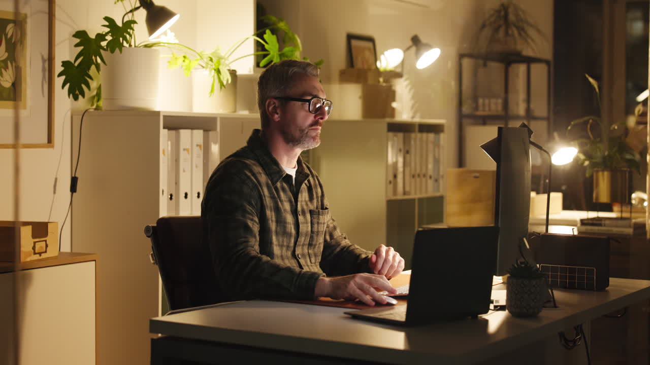 Man working on computer in home office