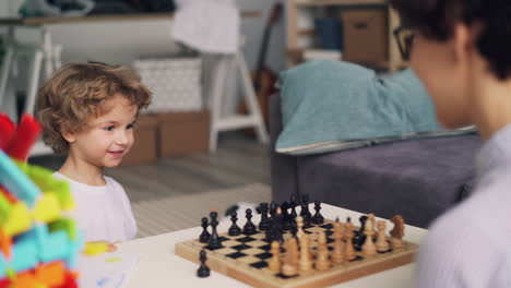 child playing chess with parent