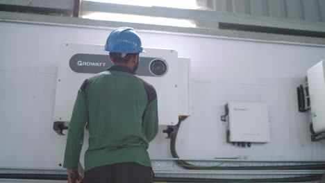 electrical engineer checking invertor in factory