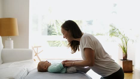madre feliz jugando y hablando con el bebé