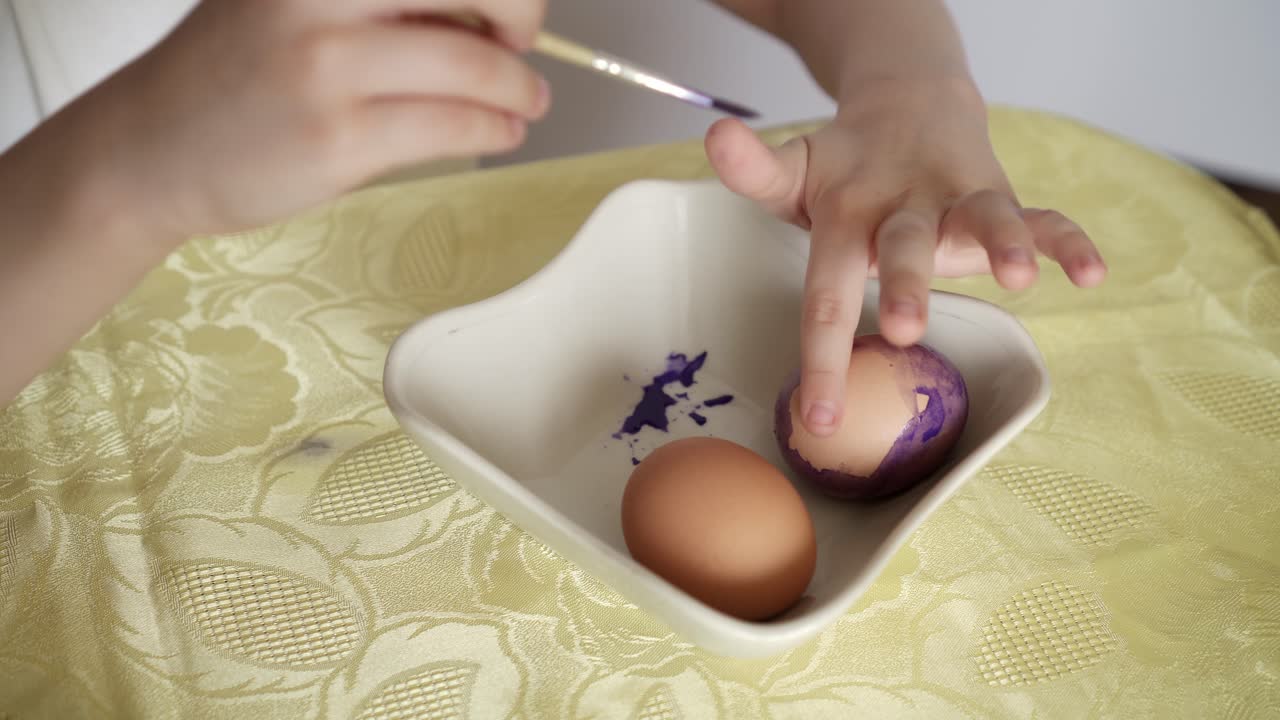 Happy Easter Holiday. Beautiful Caucasian kid boy paint and decorate eggs 02