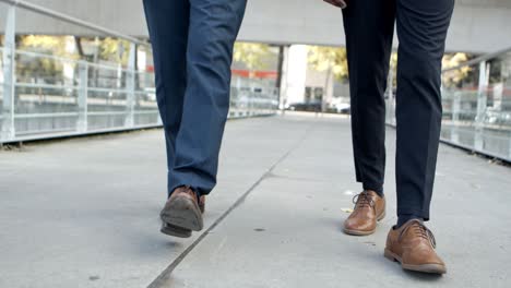 Legs-of-businessmen-walking-on-street