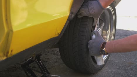 man successfully sprays aerosol into spilled tire and burns it