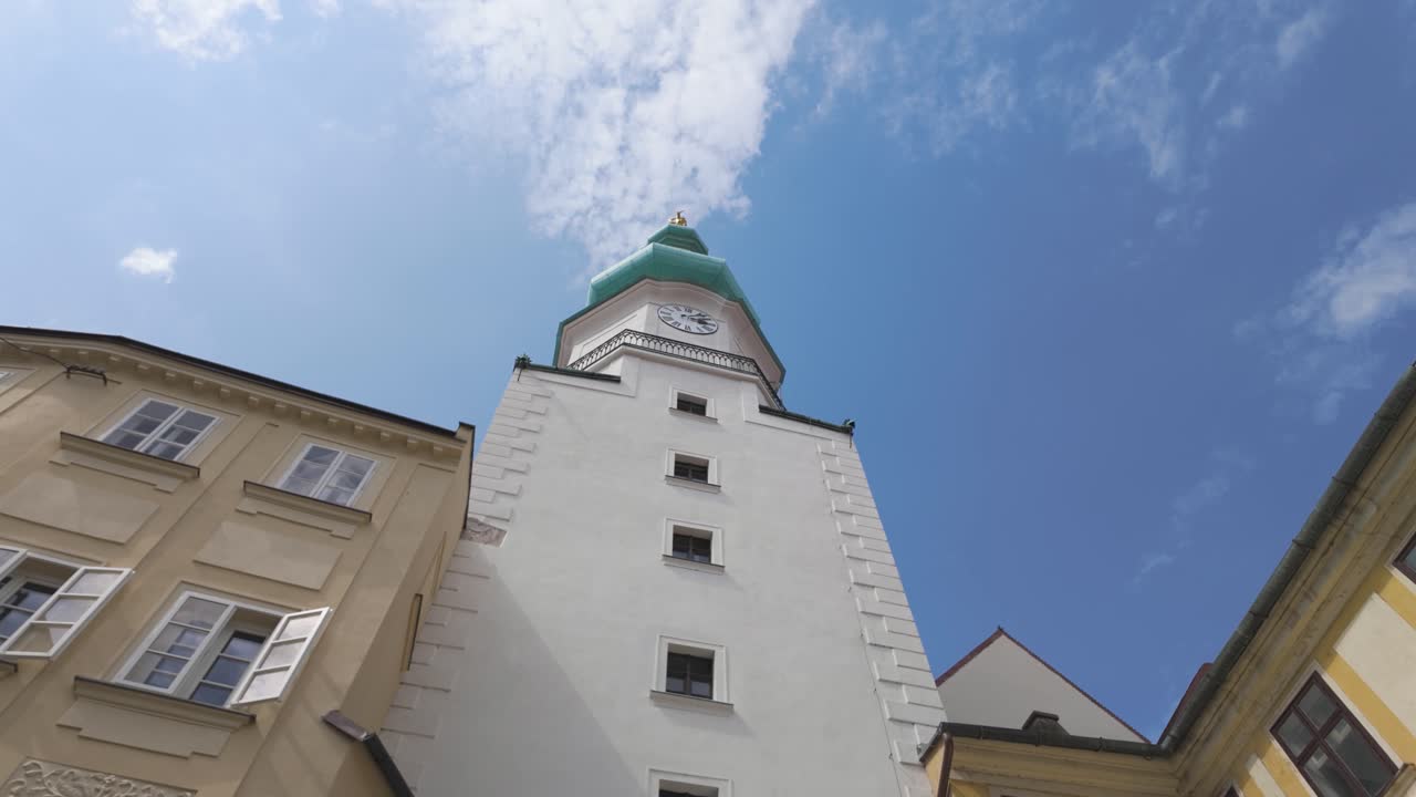 Michael's Tower stands tall under a bright blue sky in Bratislava, Slovakia
