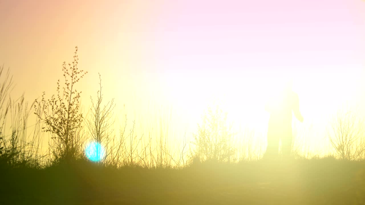Young athletic man is running outdoor in the sunset in mountain landscape.