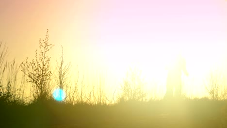 young athletic man is running outdoor in the sunset in mountain landscape.