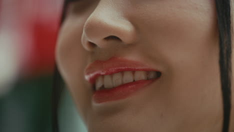 close-up of a woman's face with red lipstick