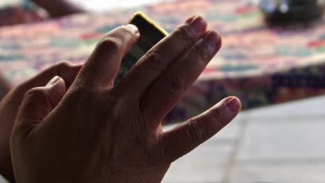 hand shooting of a male human hand cellphone playing a mobile phone game