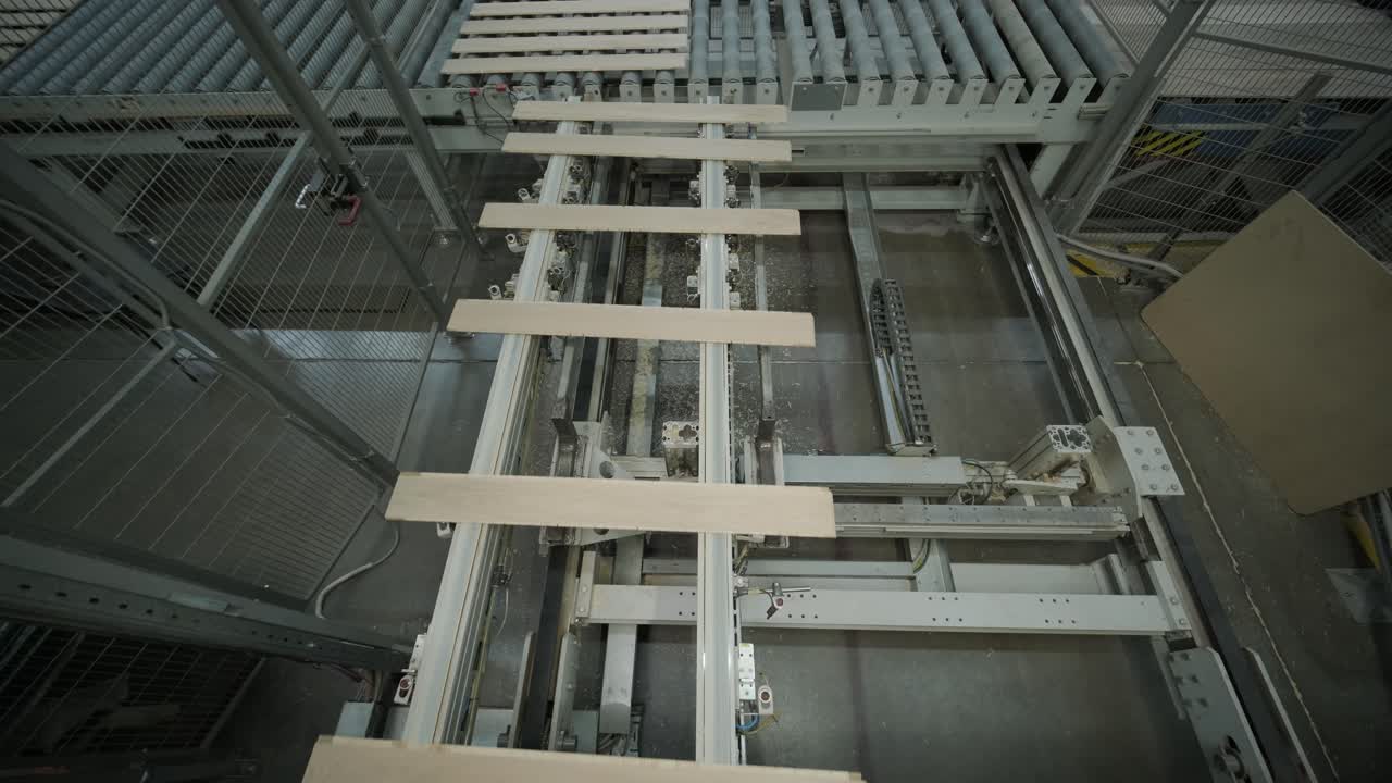 Automated Conveyor Belt System Moving Wooden Planks in a Factory