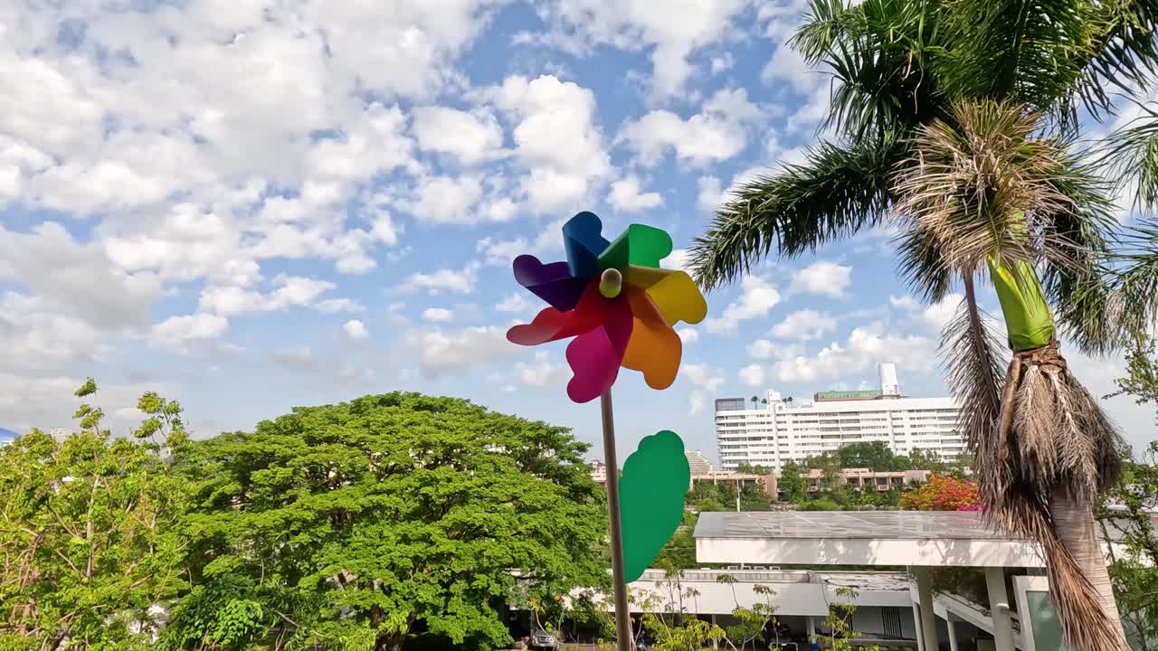 una rueda giratoria vibrante gira en un parque soleado y ventoso