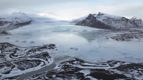 Glacier-Across-The-Frozen-Glacial-Lake-At-Winter-In-Vatnajokull-National-Park,-Iceland