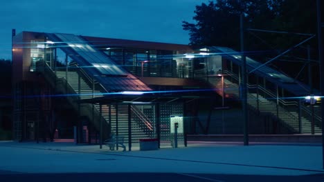 modern railway station illuminated at twilight, highlighting contemporary architecture with vibrant lights