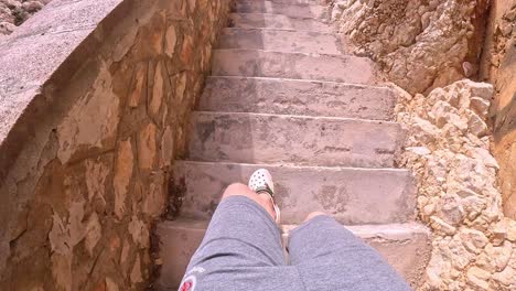 girl walks on coastal stairway in sardinia, pov reveal seaside pathway