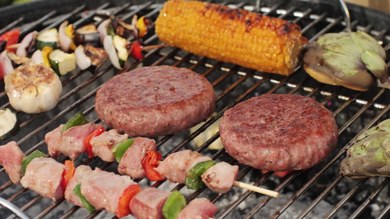 Traditional spanish barbeque, big sausage chorizo botifarra, pork and beef ribs on grill with fire, american style cooking, chef grilling meat fat food, steaks and sausages on bbq. High quality 4k footage