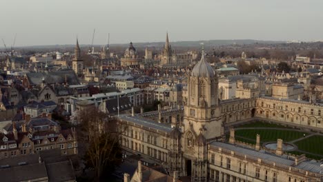 drone shot past christ church tom tower towards bodleian library radcliffe camera oxford golden hour