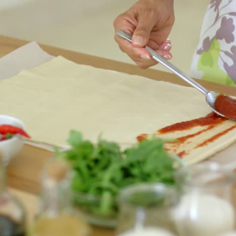 woman preparing traditional homemade pizza