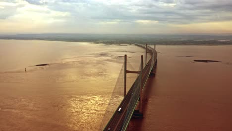 static aerial view of the second severn bridge at dawn with warm sunrise colours