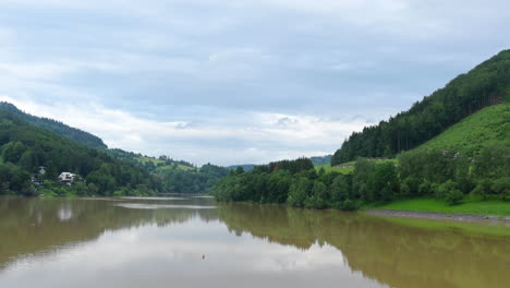 natural reservoir and landscape full of forest surrounding the mountainous area during a sunny day in the area of the bystricka reservoir