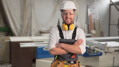 working man in overalls looks into the camera and smiles