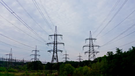 electrical transmission lines over green grass. power lines in the beautiful landscape of nature. selective focus.